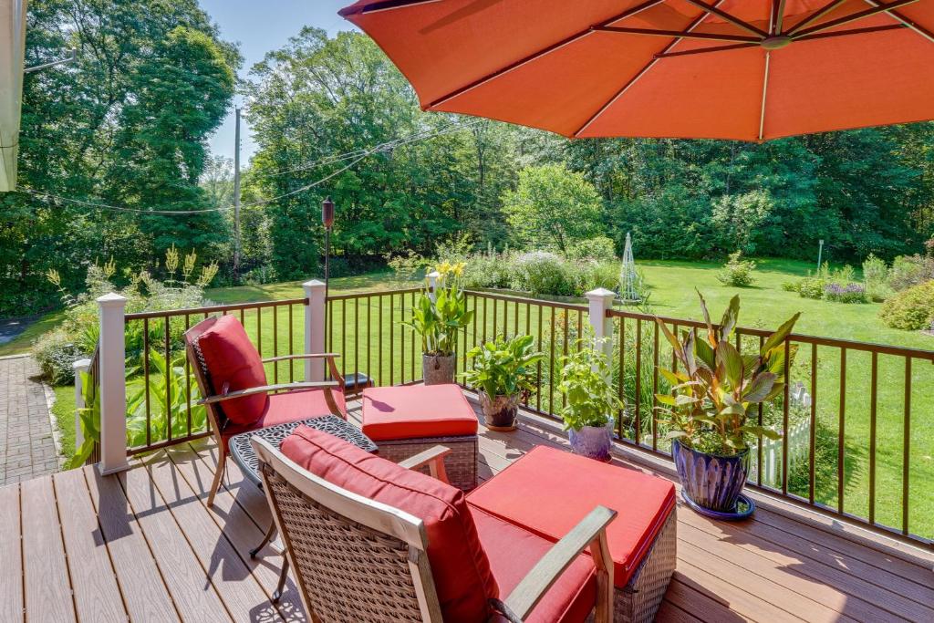 a deck with a table and chairs and an umbrella at Pet-Friendly Staatsburg Studio - Near State Park 