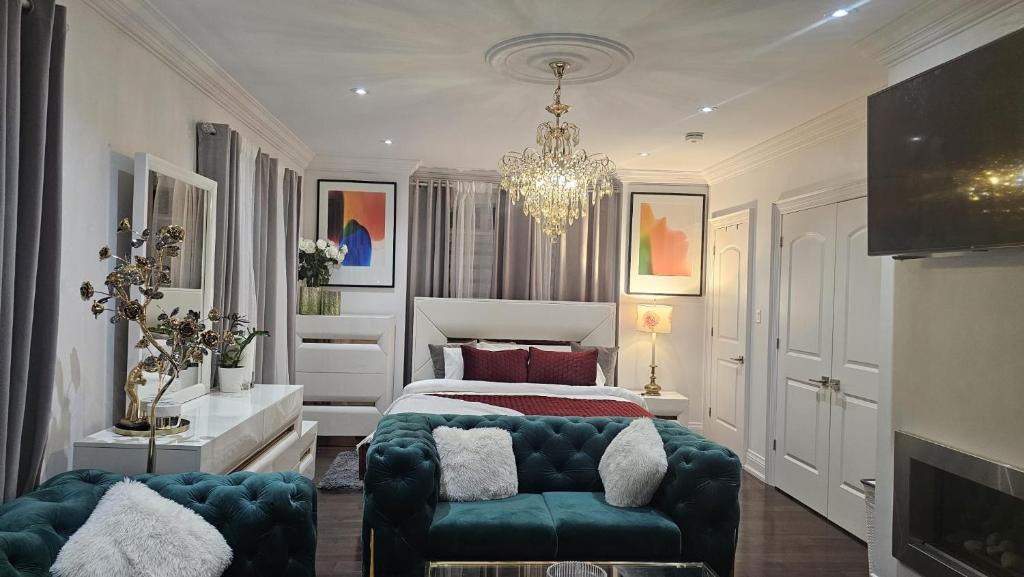 a bedroom with a bed and a couch and a chandelier at Lilen's Home in Toronto