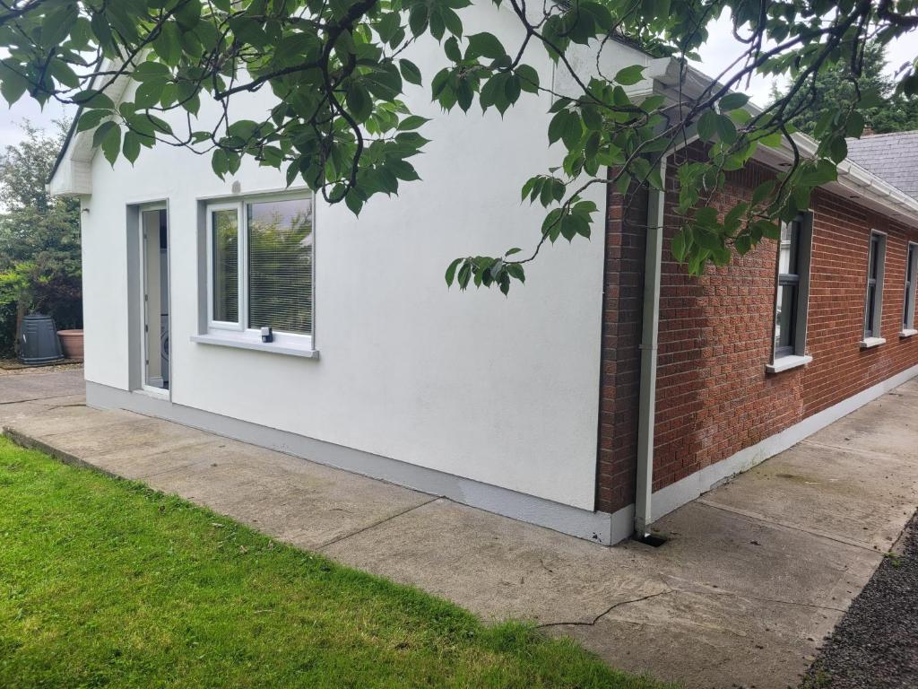 a white house with a window on the side of it at Beechwood House ,Apartment C15YA44 in Slane