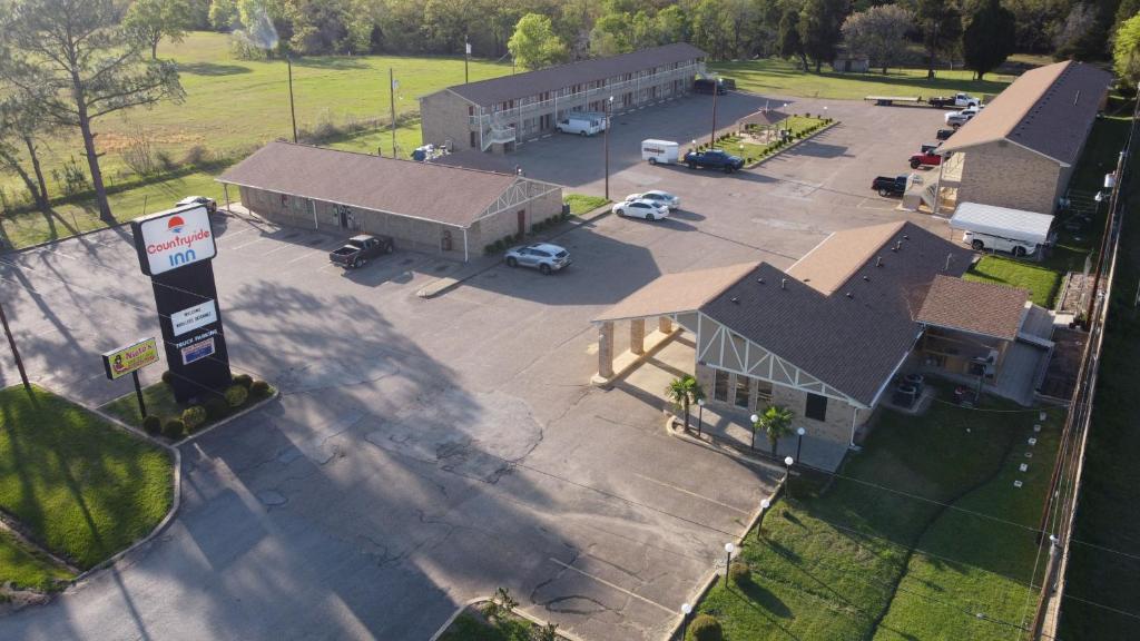 an overhead view of a building with a parking lot at Countryside Inn in Malakoff