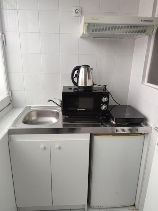 a kitchen with a tea kettle on top of a microwave at Expérience urbaine in Aubervilliers