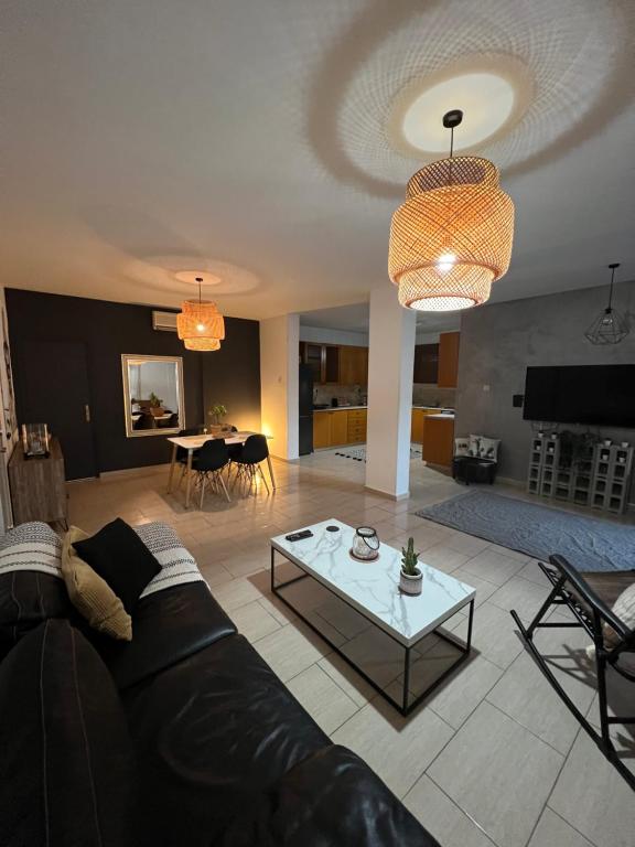 a living room with a couch and a table at Green Door Apartment in Limassol