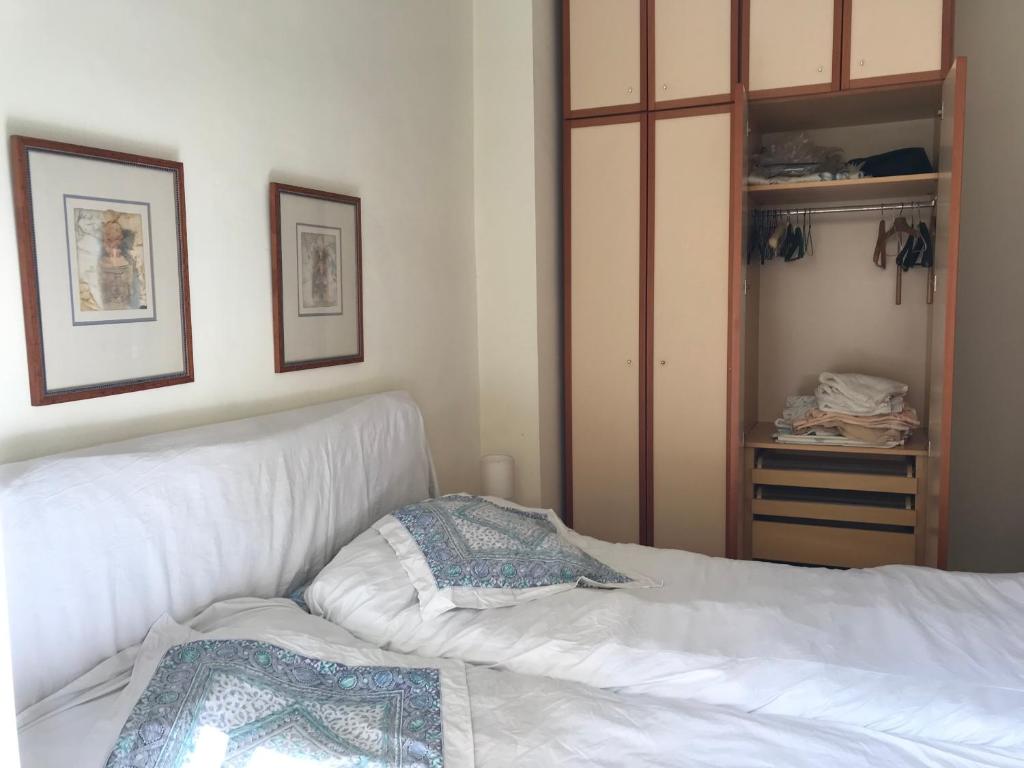 a bedroom with a white bed and a closet at Private SINGLE room in RUZAFA, ladies only, non smoker in Valencia