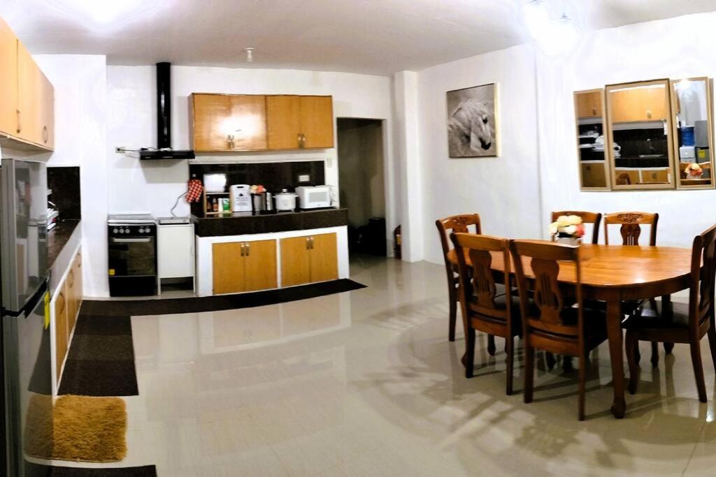 a kitchen and dining room with a table and chairs at Stellar Homesharing (Home #2) in Davao City
