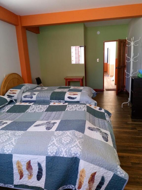 a bedroom with two beds with a quilt on them at Suma Qamaña in Copacabana