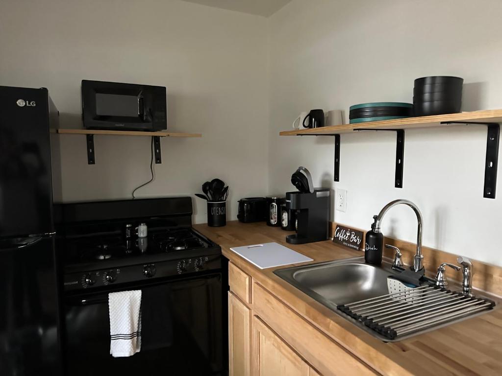 a kitchen with a sink and a stove at Tiny House in Statesville