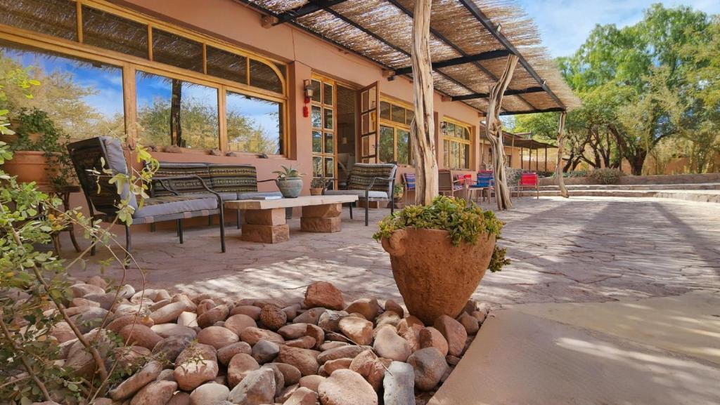 a patio with a bunch of rocks in front of a building at Hotel Tulor in San Pedro de Atacama