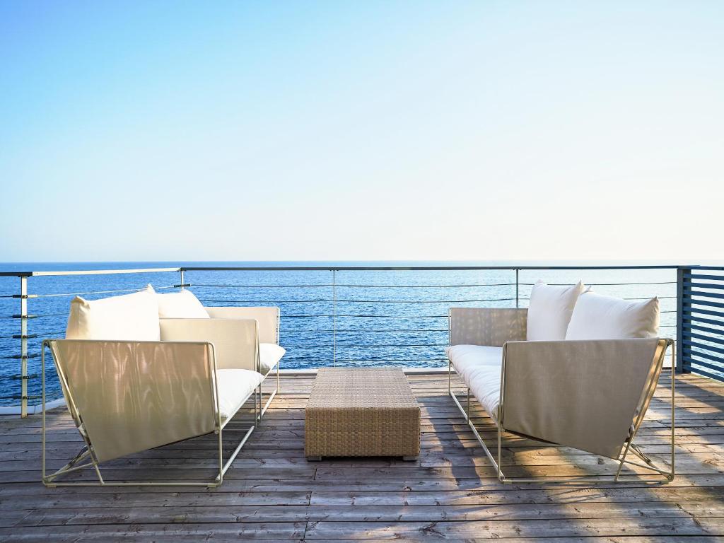 a deck with a couch and chairs on a boat at &SUN Penthouse in Yokosuka