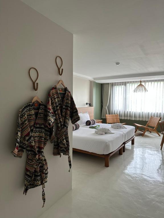 En eller flere senge i et værelse på HOTEL NUU CHIANG MAI