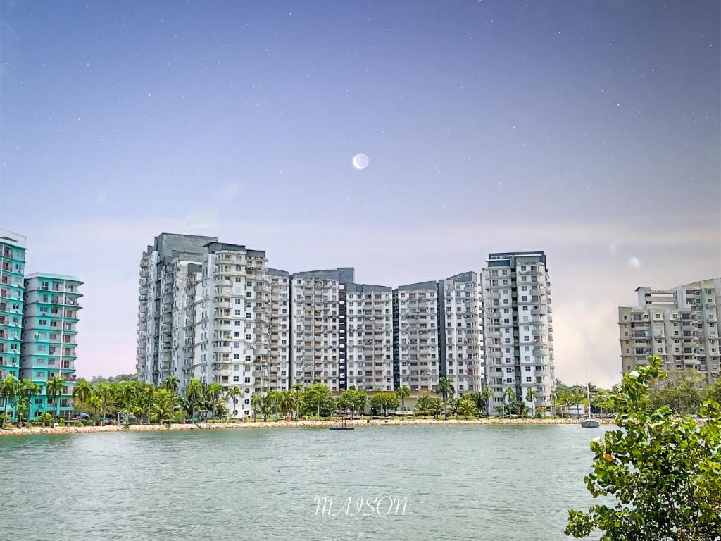 a large apartment building next to a body of water at BayView Suites Port Dickson By MAISON in Port Dickson