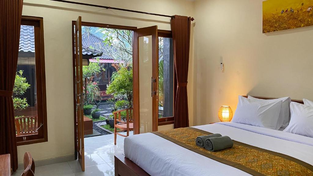 Postel nebo postele na pokoji v ubytování Bojig House Ubud