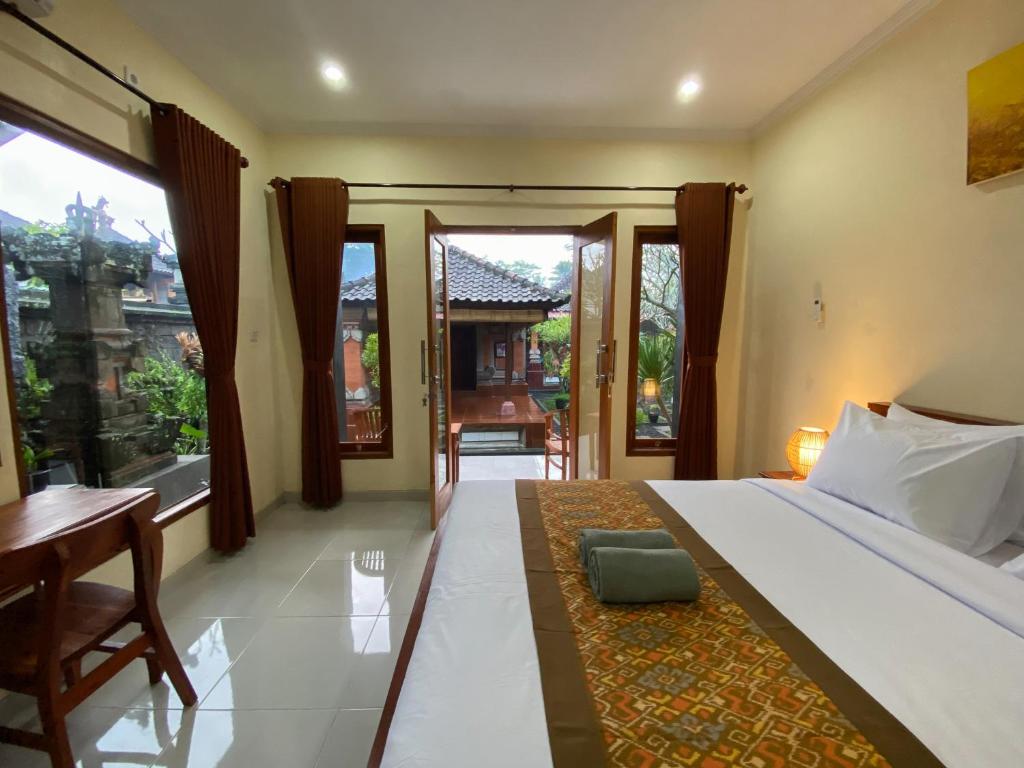 Postel nebo postele na pokoji v ubytování Bojig House Ubud