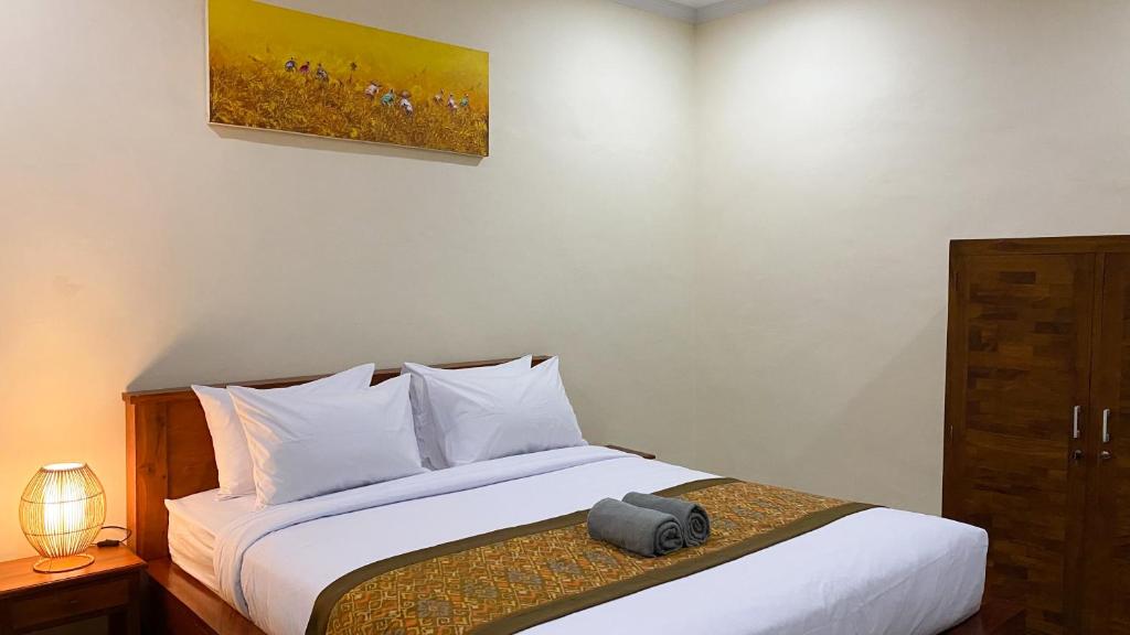 Postel nebo postele na pokoji v ubytování Bojig House Ubud