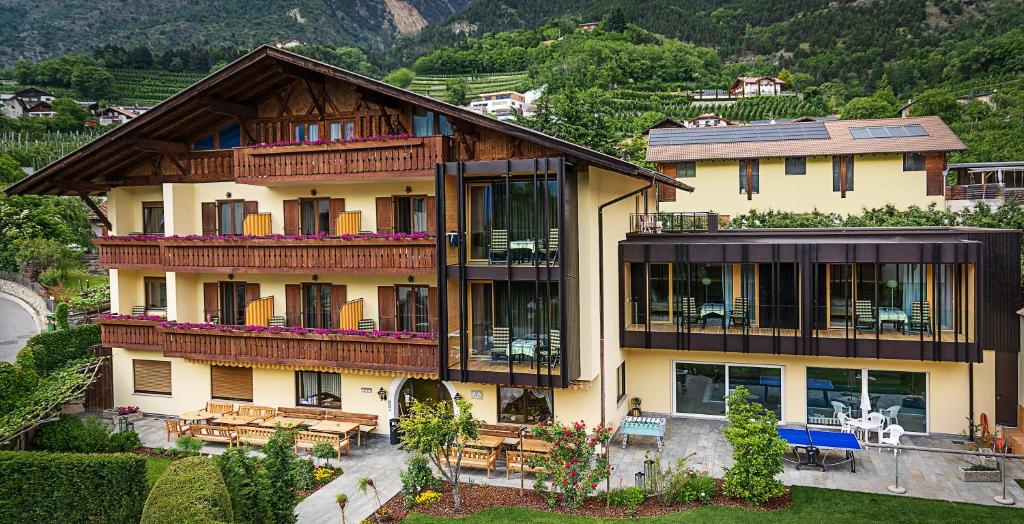 un gran edificio con bancos delante en Hotel Obermoosburg en Coldrano