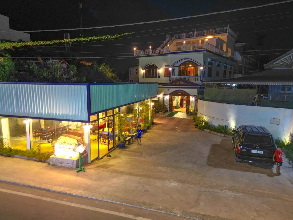 an empty parking lot in front of a building at night at Blossoming Romduol Boutique in Siem Reap