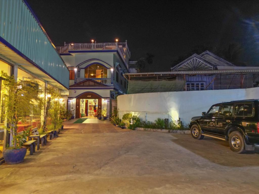a car parked in front of a building at night at Blossoming Romduol Boutique in Siem Reap