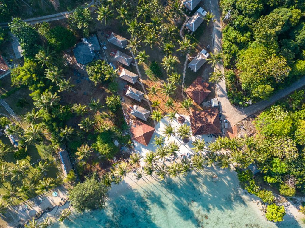 an overhead view of a resort with palm trees and water at Eco Casa in Karimunjawa