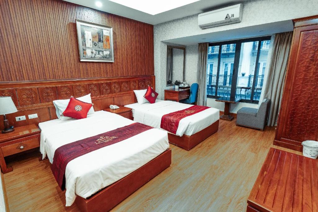 Postel nebo postele na pokoji v ubytování Lefoyer Hotel