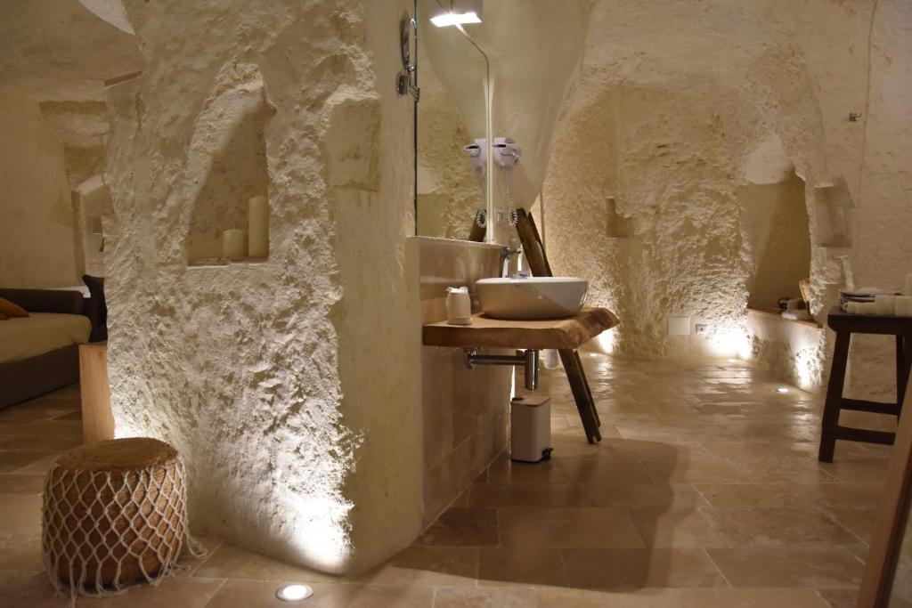a bathroom with a sink in a stone wall at Il Belvedere in Matera