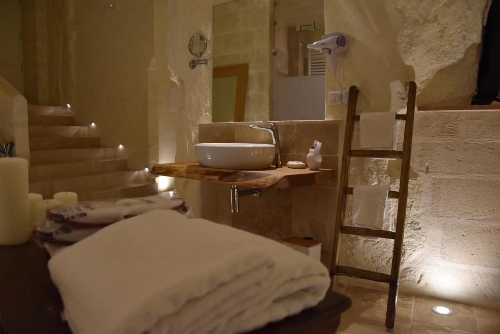 a bathroom with a sink and a counter with towels at Il Belvedere in Matera