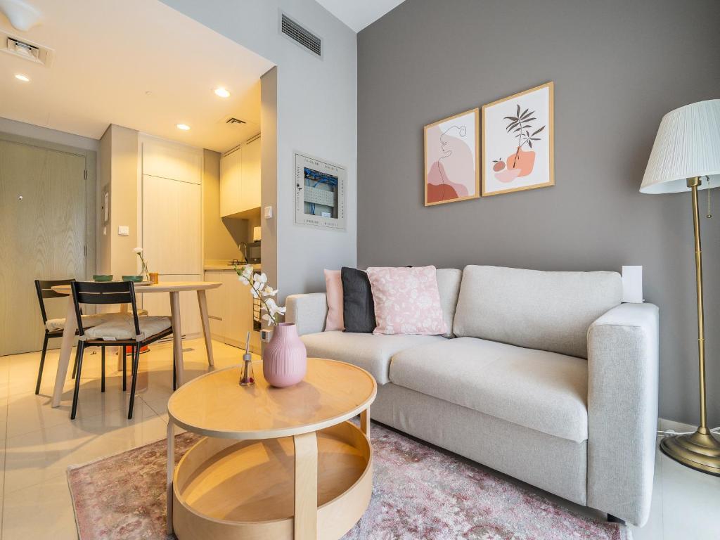 una sala de estar con un sofá y una mesa en Business Bay's Coziest Hideaway With Balcony, en Dubái