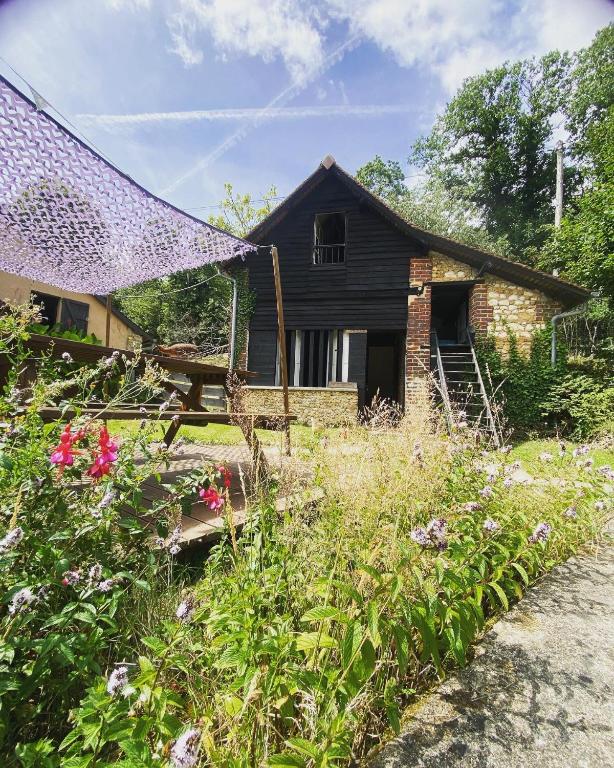 an old house with some flowers in front of it at Loire Valley Llama Farm Stay in Lavernat