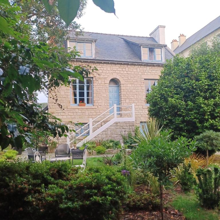 a brick house with a staircase in front of it at Le Banellou in Quimper