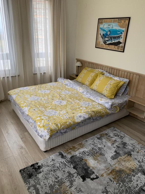 a bedroom with a bed and a rug at Private Apartment Pirin Golf Club with Lake View in Razlog