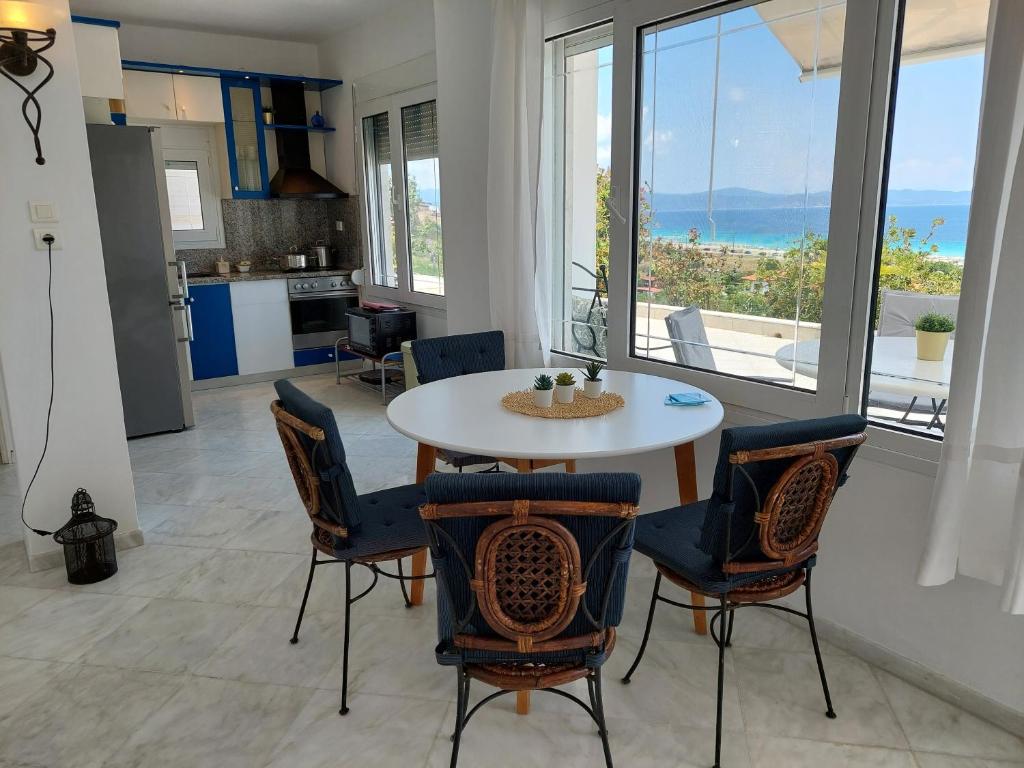 a kitchen and dining room with a table and chairs at Seaview dreams in Ormos Panagias