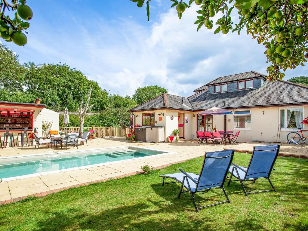 a house with a pool and chairs in the yard at Pheasants Haunt in Goodrington