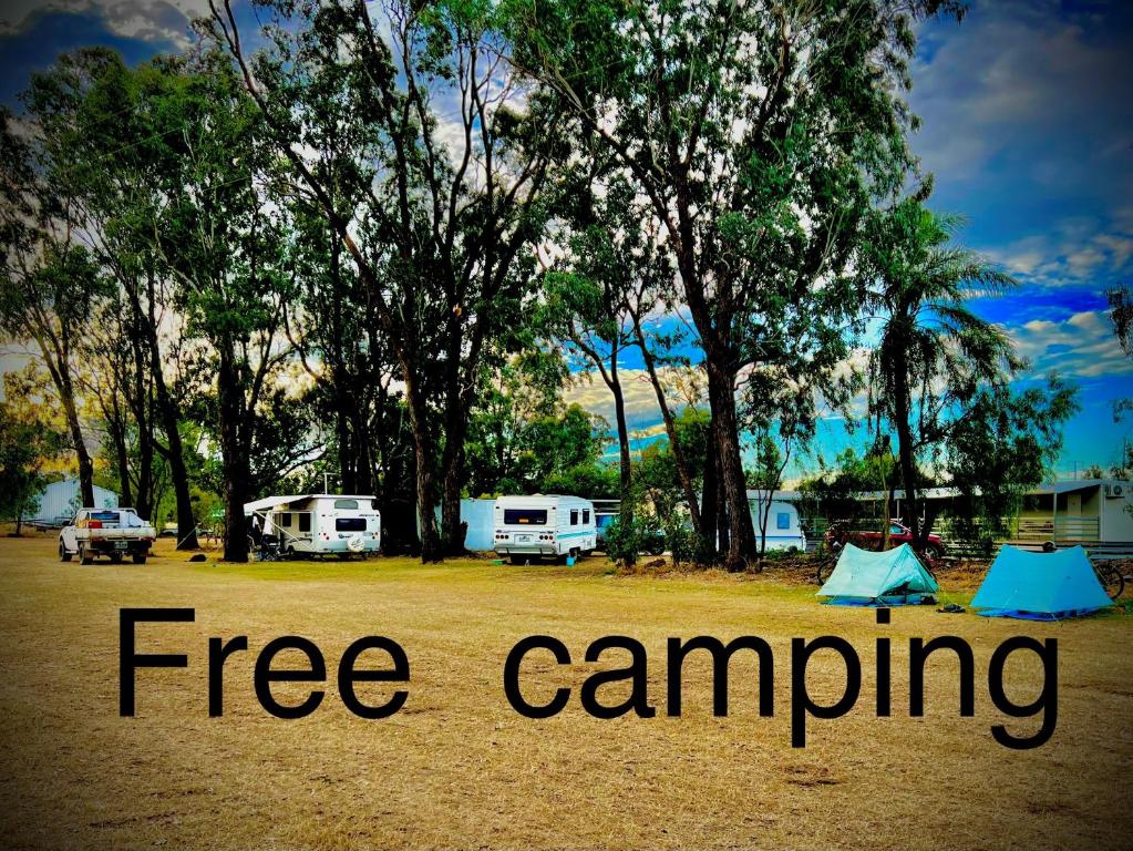 a group of tents in a field with trees at Jambin hotel motel 