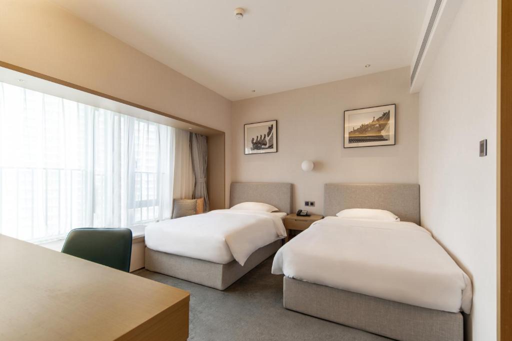 Postel nebo postele na pokoji v ubytování Keypai Hotel