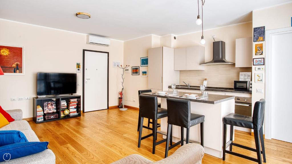 a kitchen with a table and chairs in a room at Italianway Comfort - Salasco 18 in Milan