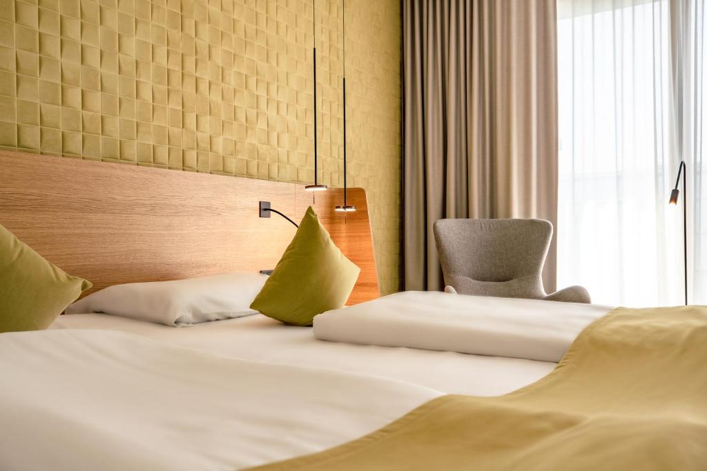Postel nebo postele na pokoji v ubytování Novotel Karlsruhe City
