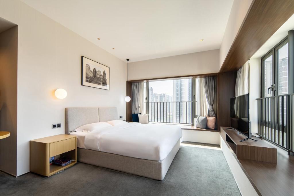 Postel nebo postele na pokoji v ubytování Keypai Hotel