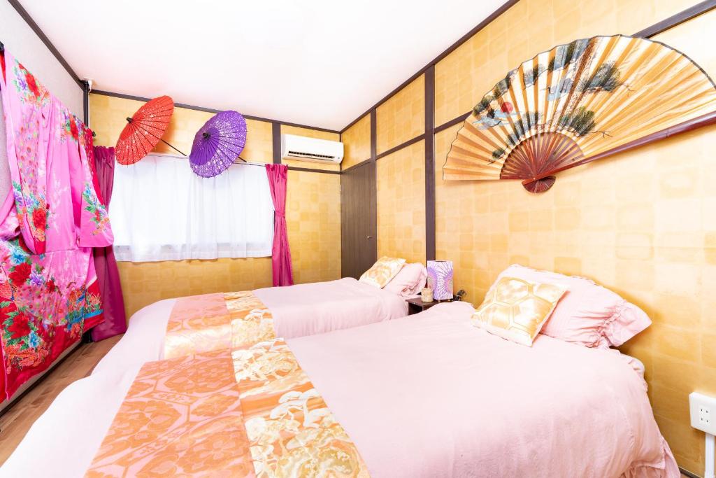 a bedroom with two beds and a window at Ikebukuro Max14ppl 6bedrooms 11beds 1200sqft in Tokyo