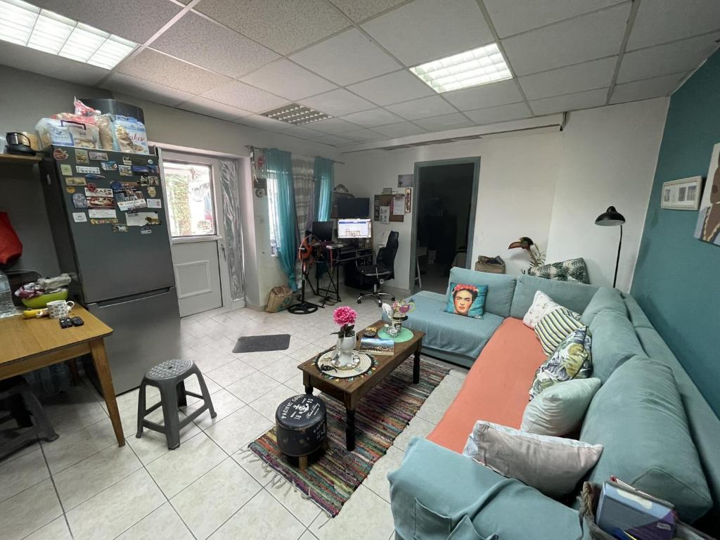 a living room with a blue couch and a table at Filoxenos Houses Corfu Island in Mantoúkion