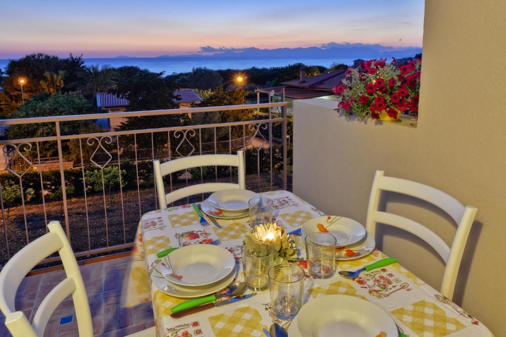 a table with plates and dishes on top of a balcony at Casa Vacanze Villa Liotta in Agropoli