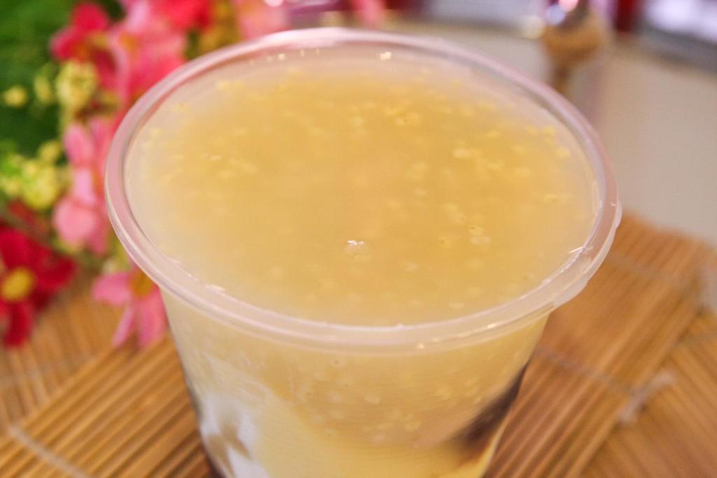 a plastic cup of yellow liquid sitting on a table at Itathao Vacation Hotel in Yuchi