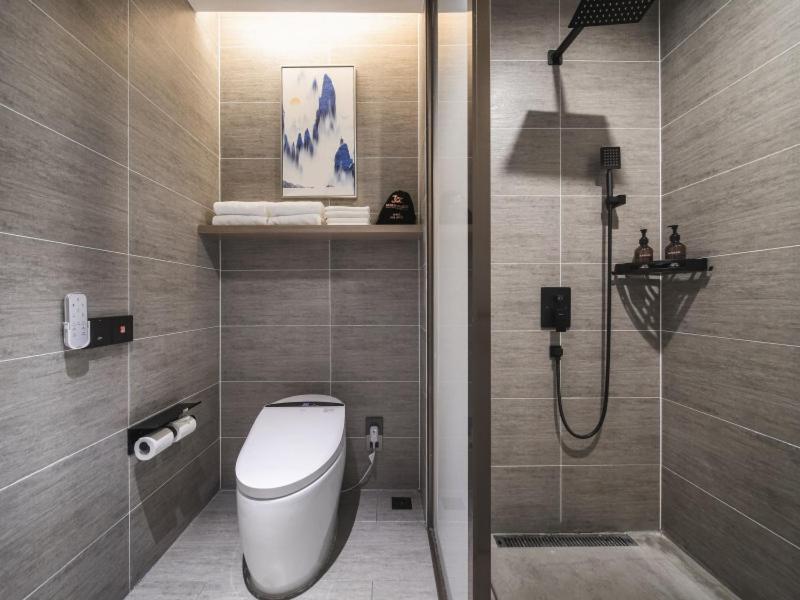 a bathroom with a toilet and a shower in it at GreenTree Eastern Hotel Chuzhou Suchu Industrial Park in Chuzhou