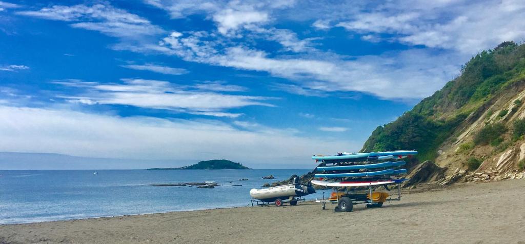 a beach with a bunch of surfboards on the sand at 2 bedroom luxury beach apartment Millendreath in Saint Martin