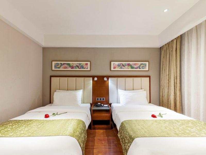 Postel nebo postele na pokoji v ubytování GreenTree Eastern Hotel Fujian Xiamen Railway Station Mingfa Plaza
