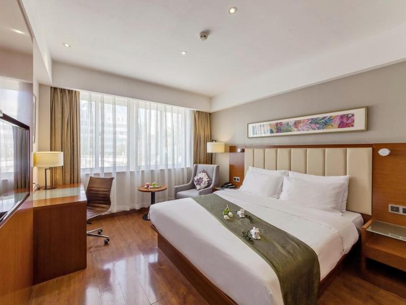 Postel nebo postele na pokoji v ubytování GreenTree Eastern Hotel Fujian Xiamen Railway Station Mingfa Plaza