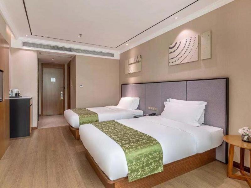 Postel nebo postele na pokoji v ubytování GreenTree Eastern Hotel Fujian Xiamen Railway Station Mingfa Plaza