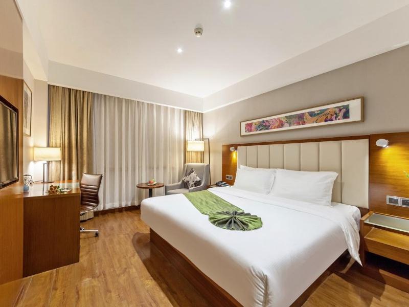 Postel nebo postele na pokoji v ubytování GreenTree Eastern Hotel Fujian Xiamen Railway Station Mingfa Plaza
