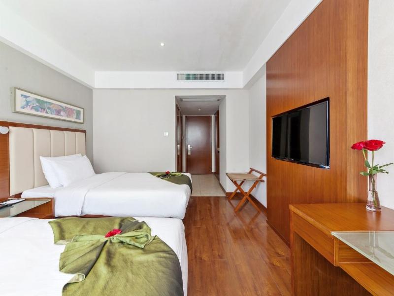 Postel nebo postele na pokoji v ubytování GreenTree Eastern Hotel Fujian Xiamen Railway Station Mingfa Plaza
