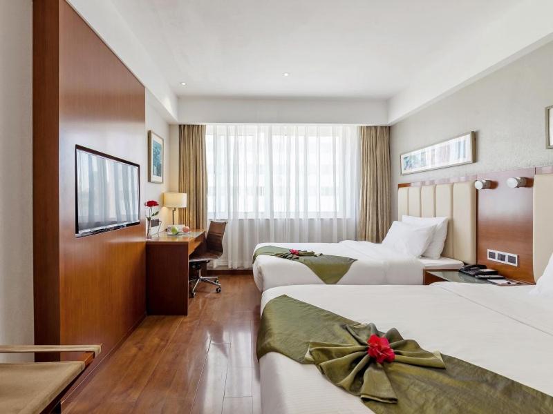 Postel nebo postele na pokoji v ubytování GreenTree Eastern Hotel Fujian Xiamen Railway Station Mingfa Plaza