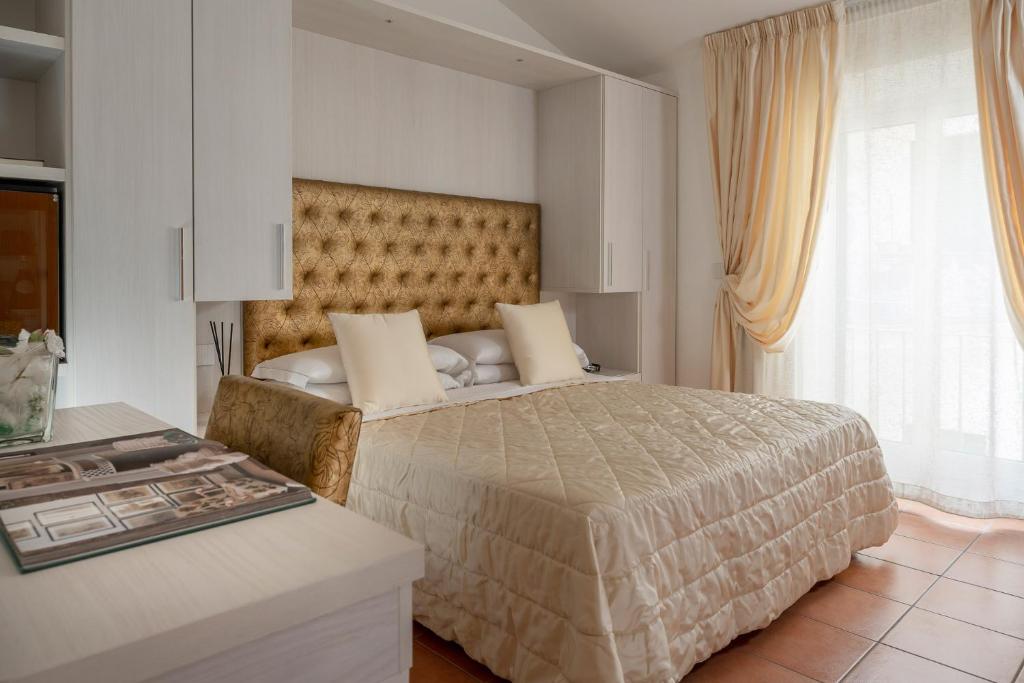 Postel nebo postele na pokoji v ubytování Albergo Rossini 1936