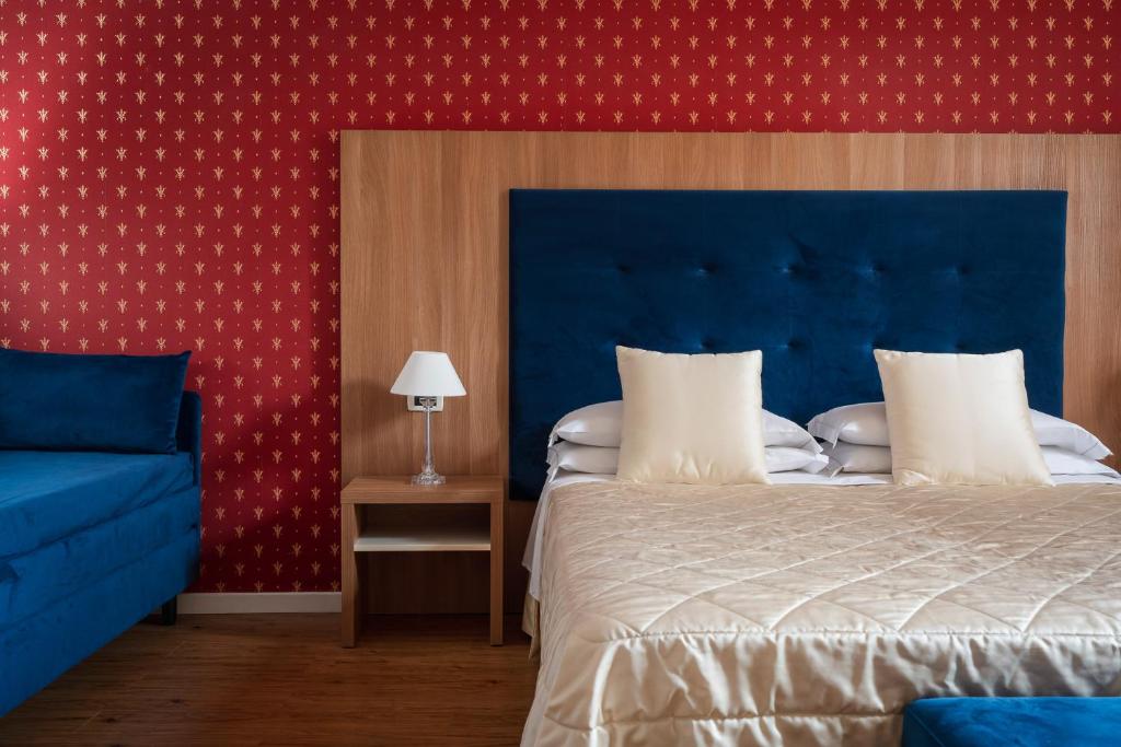 Postel nebo postele na pokoji v ubytování Albergo Rossini 1936
