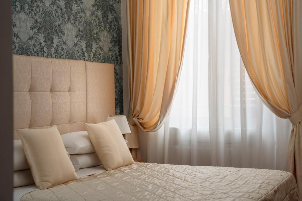 Postel nebo postele na pokoji v ubytování Albergo Rossini 1936